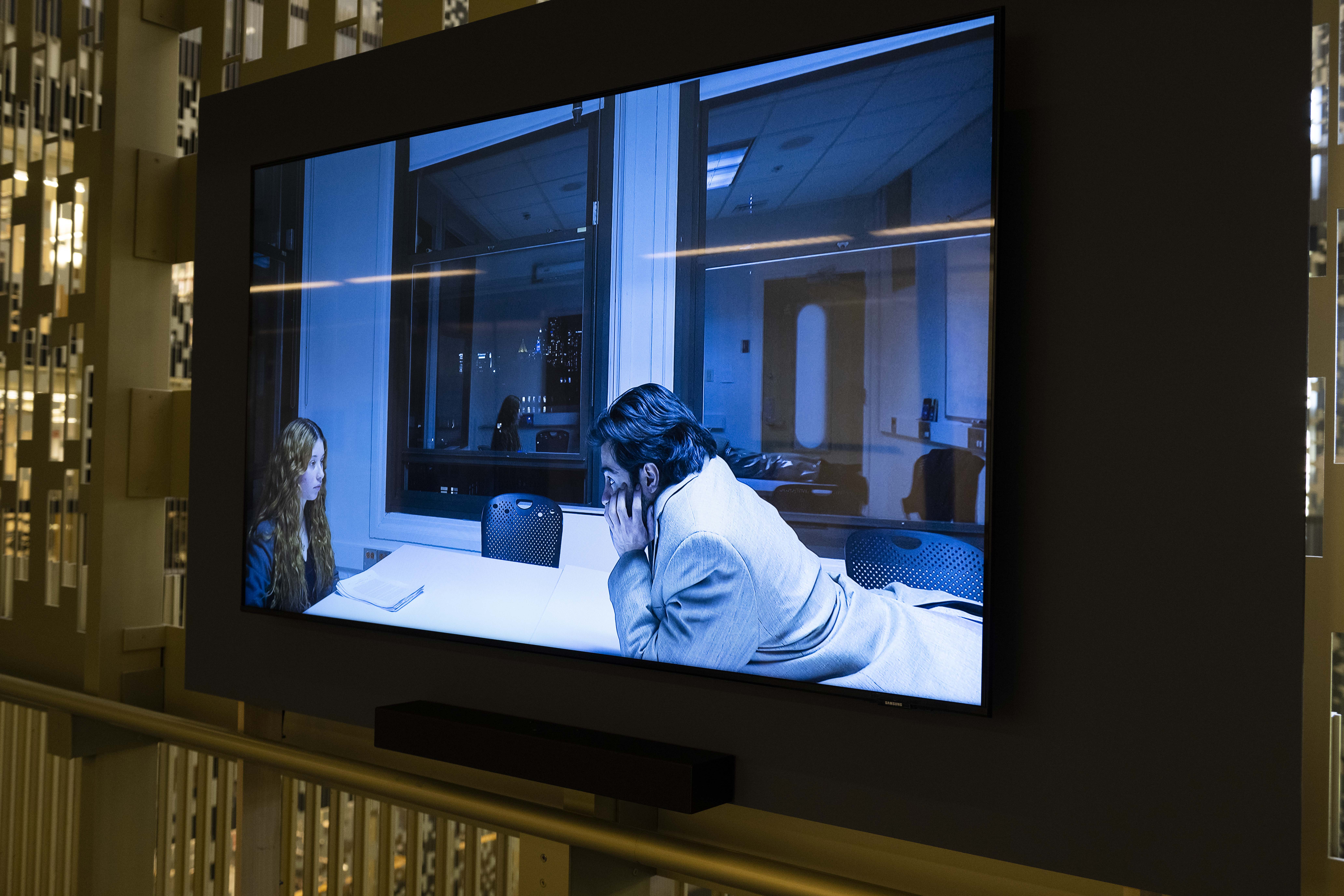 Detail image of two people on a video screen