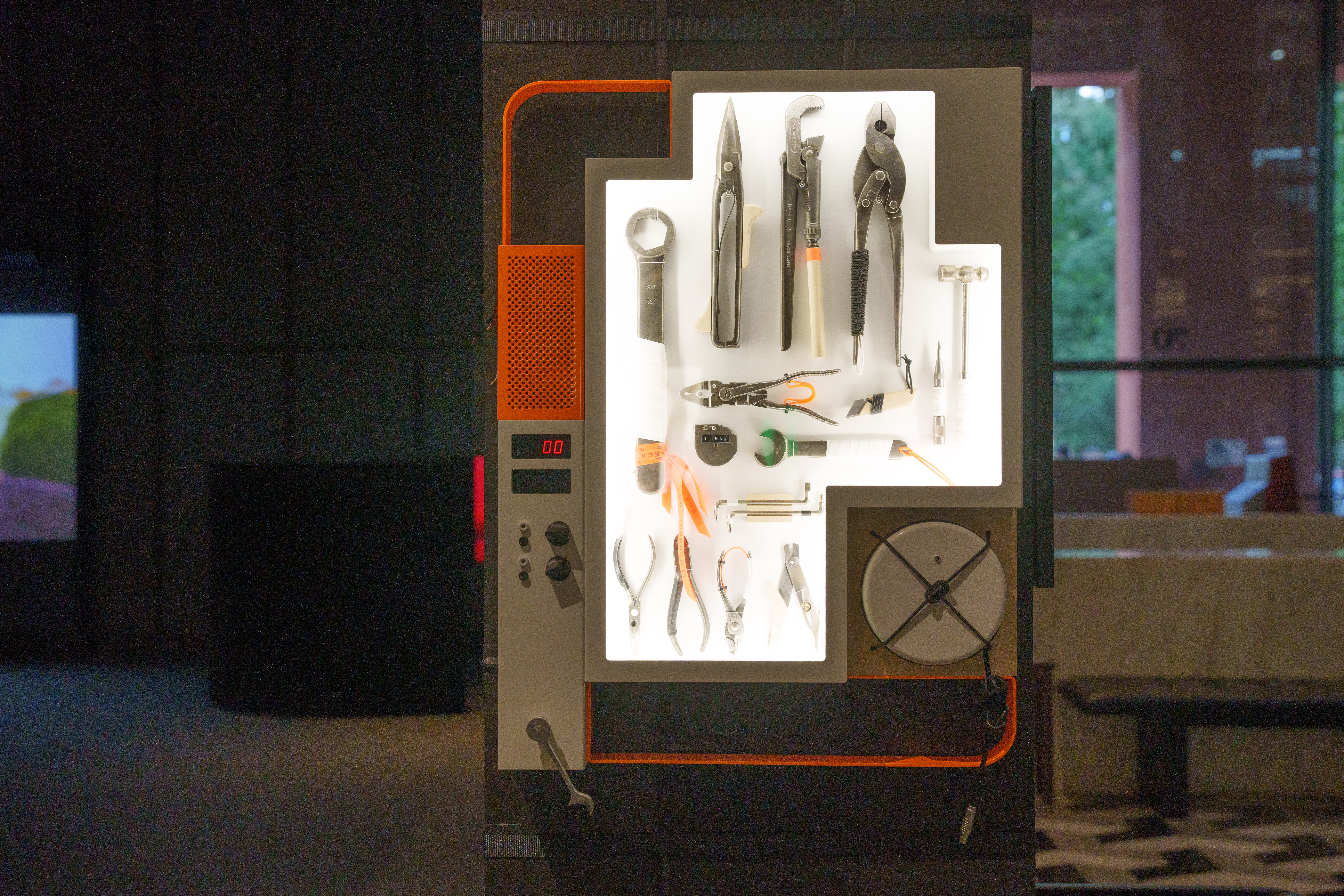 Detail image of white cabinet wwith objects and electronic screens