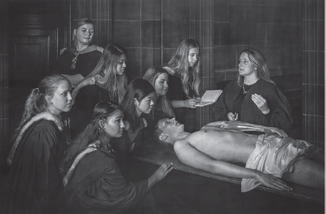 A photograph of 8 women in a classroom. One woman is looking at a cadaver on the table while others take notes.