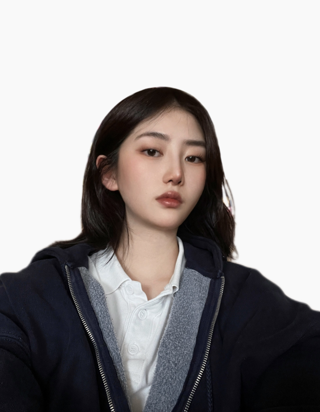 Photograph of person with long dark brown hair, light beige skin, wearing a dark blue zippered jacket with a white shirt